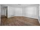 Bright living area featuring wood-look floors, white walls, and a window, offering a clean and modern aesthetic at 6165 Short St, Canton, GA 30114