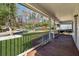 Spacious covered porch with stained wood flooring, white railings, and a view of the street and neighborhood at 6165 Short St, Canton, GA 30114