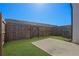 Spacious back yard featuring a wooden fence, grassy area, and concrete patio at 76 Auburn Run Ln, Auburn, GA 30011