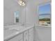 Bright bathroom featuring a double sink vanity, quartz countertop, and a window providing natural light at 76 Auburn Run Ln, Auburn, GA 30011