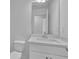 Modern bathroom with white cabinets, marble countertop, and a large mirror at 76 Auburn Run Ln, Auburn, GA 30011