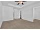 This bedroom showcases a ceiling fan, plush carpets, and an ensuite bathroom and walk-in closet at 76 Auburn Run Ln, Auburn, GA 30011