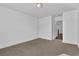Comfortable bedroom featuring neutral carpeting, white walls, and a closet at 76 Auburn Run Ln, Auburn, GA 30011