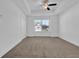 Neutral bedroom with plush carpeting and a window offering lots of natural light at 76 Auburn Run Ln, Auburn, GA 30011