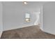 Well-lit room features neutral carpeting, white walls, and a window at 76 Auburn Run Ln, Auburn, GA 30011