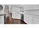 Bright kitchen with white cabinets, stainless steel appliances, and hardwood floors at 76 Auburn Run Ln, Auburn, GA 30011