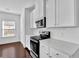 Bright kitchen with white cabinets, stainless steel appliances, and subway tile backsplash at 76 Auburn Run Ln, Auburn, GA 30011