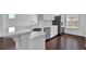 Modern kitchen features white cabinets, stainless appliances, and granite countertops at 76 Auburn Run Ln, Auburn, GA 30011