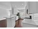 Modern kitchen with white cabinets, quartz countertops, stainless steel appliances, and hardwood floors at 76 Auburn Run Ln, Auburn, GA 30011