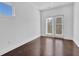 Bright room with hardwood floors and glass doors leading outside at 76 Auburn Run Ln, Auburn, GA 30011