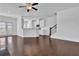Open-concept living space with hardwood floors, adjacent to kitchen, with backyard view at 76 Auburn Run Ln, Auburn, GA 30011