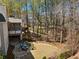 Expansive backyard with stone patio, lush lawn, and mature trees, creating a private oasis at 302 W Country Dr, Johns Creek, GA 30097