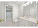 All-white bathroom with shower/tub combination and vanity with a bright countertop and lighting at 302 W Country Dr, Johns Creek, GA 30097