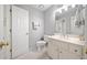 Cozy bathroom featuring a toilet, towel rack, and a vanity with bright countertop and mirror at 302 W Country Dr, Johns Creek, GA 30097