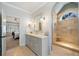 This lovely bathroom has a gorgeous walk-in shower with a glass door and is open to the main bedroom at 302 W Country Dr, Johns Creek, GA 30097