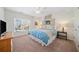 Bedroom with carpet, ceiling fan, and ample natural light with king bed and side tables at 302 W Country Dr, Johns Creek, GA 30097