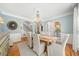 Charming dining room with hardwood floors, wainscoting, and a chandelier at 302 W Country Dr, Johns Creek, GA 30097