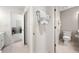 Bright hallway bathroom featuring tile flooring, white trim, and convenient access to a bedroom at 302 W Country Dr, Johns Creek, GA 30097