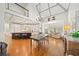 Open-concept kitchen and dining area with hardwood floors, island, and stainless appliances at 302 W Country Dr, Johns Creek, GA 30097
