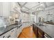 Gourmet kitchen featuring modern appliances and a decorative backsplash with barstool seating at 302 W Country Dr, Johns Creek, GA 30097