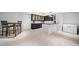 Tile floor basement kitchenette area with a table and two chairs, a refrigerator, and modern cabinetry at 302 W Country Dr, Johns Creek, GA 30097