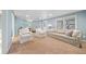 Bright living room with neutral palette, plush carpet, and comfortable seating arrangement at 302 W Country Dr, Johns Creek, GA 30097