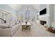 Light-filled living room with cathedral ceiling, fireplace, and large windows at 302 W Country Dr, Johns Creek, GA 30097