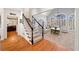 Bright living room with hardwood floors, staircase and cathedral ceiling at 302 W Country Dr, Johns Creek, GA 30097