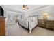 Relax in this spacious main bedroom featuring a decorative ceiling, ceiling fan, and lots of natural light at 302 W Country Dr, Johns Creek, GA 30097