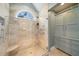 Enjoy this walk-in shower with multiple shower heads, a seating area, and neutral tile at 302 W Country Dr, Johns Creek, GA 30097