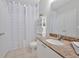 Well-lit bathroom featuring a granite countertop, white cabinetry, and tiled floor at 10 Perimeter Summit Ne Blvd # 1208, Brookhaven, GA 30319