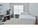 Cozy bedroom with white carpet, window, dark furniture, and study area at 10 Perimeter Summit Ne Blvd # 1208, Brookhaven, GA 30319