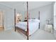 Well-lit bedroom with a four-poster bed, neutral colors, and a view to the bathroom at 10 Perimeter Summit Ne Blvd # 1208, Brookhaven, GA 30319
