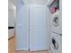 Laundry closet with a stacked washer and dryer and storage space at 10 Perimeter Summit Ne Blvd # 1208, Brookhaven, GA 30319