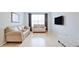 Bright living room features hardwood floors, large window, and neutral-toned furniture at 10 Perimeter Summit Ne Blvd # 1208, Brookhaven, GA 30319