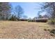 Expansive backyard featuring a well-maintained lawn and mature trees at 6175 Marilla St, Douglasville, GA 30135