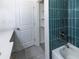 Updated bathroom featuring blue tile in shower, white countertops, and storage at 6175 Marilla St, Douglasville, GA 30135