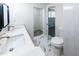 Modern bathroom features double sinks, marble floors, and sleek white tile surround at 6175 Marilla St, Douglasville, GA 30135