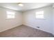 Bright bedroom with two large windows, neutral walls, and carpet flooring at 6175 Marilla St, Douglasville, GA 30135
