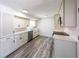 Spacious kitchen features white cabinets, modern appliances, and wood-look flooring at 6175 Marilla St, Douglasville, GA 30135