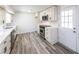Bright kitchen boasts stainless steel appliances, white cabinets, and quartz countertops at 6175 Marilla St, Douglasville, GA 30135