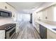 Open concept kitchen features stainless appliances, white cabinets, and seamless flow to living area at 6175 Marilla St, Douglasville, GA 30135