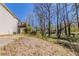 View of the backyard showing grass, trees and the back of the house at 1270 Della Way, Lawrenceville, GA 30043