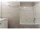 Clean bathroom featuring a white tiled tub and updated fixtures at 1270 Della Way, Lawrenceville, GA 30043