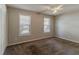 Bedroom includes carpet, two windows, and a ceiling fan at 1270 Della Way, Lawrenceville, GA 30043