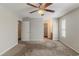 A spacious bedroom featuring a ceiling fan, and a walk-in closet at 1270 Della Way, Lawrenceville, GA 30043