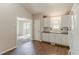 Modern kitchen featuring white cabinets, stainless steel appliances, and wood flooring at 1270 Della Way, Lawrenceville, GA 30043