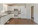 Bright kitchen featuring white cabinets, stainless steel appliances, and black countertops at 1270 Della Way, Lawrenceville, GA 30043