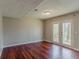 Living room featuring hardwood floors and double doors to the yard at 1270 Della Way, Lawrenceville, GA 30043