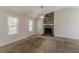 Spacious living room featuring a stone fireplace, carpeted floor, and lots of natural light at 1270 Della Way, Lawrenceville, GA 30043